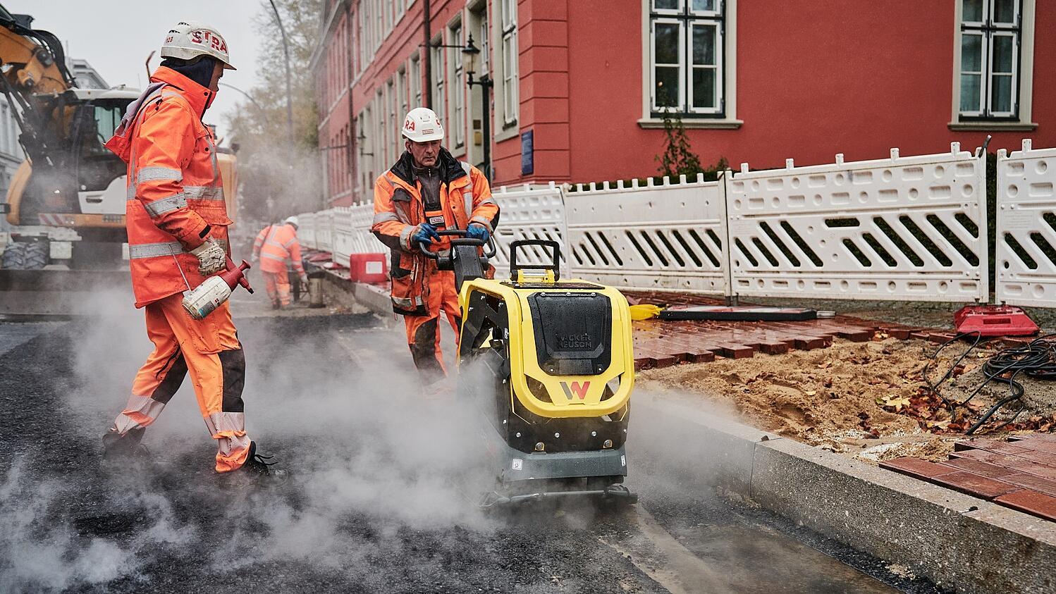 Construction workers paving road with DPU62