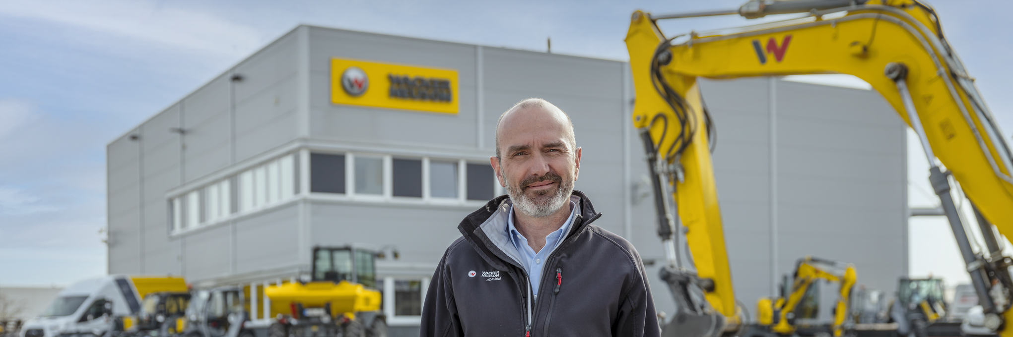 Wacker Neuson employee standing in front of Wacker Neuson rental station.