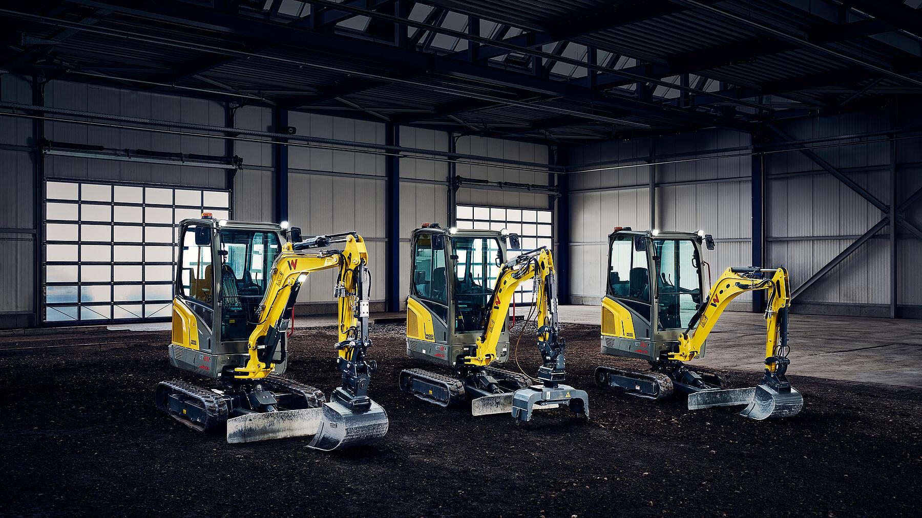 Mini-excavators standing in big hall