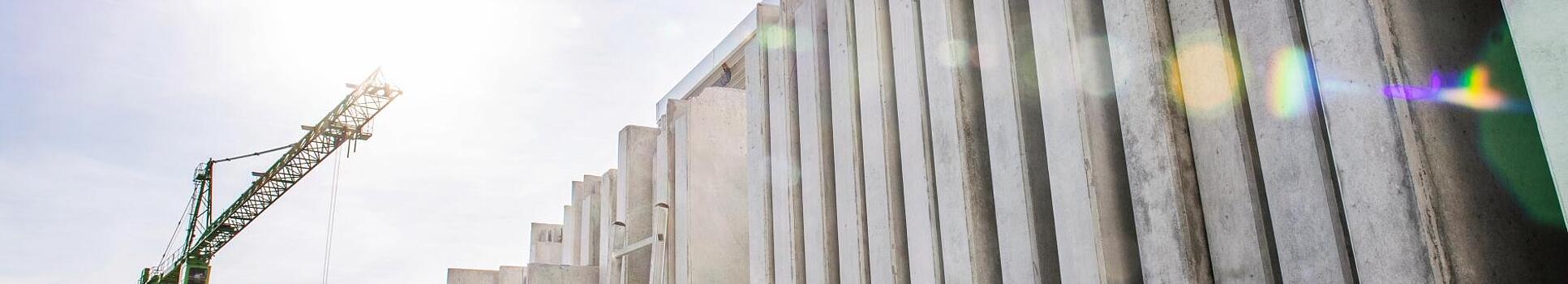 Concrete walls standing vertically on a construction site.